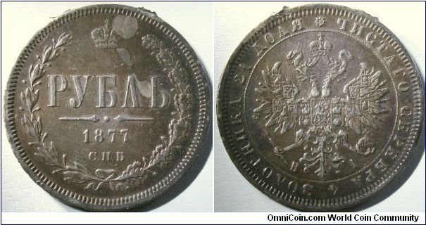 Russia 1877 1 ruble. There was an attempt to convert this into a jewellery piece (a hole at the top of the obverse), but fortunately, whoever did that failed. You can still see a bit of the mount mark left on the top.