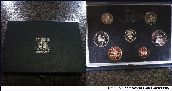 UK 1985 proof set. Comes with a box and COA. Funny how the COA describes the 50p as 13.50kg

Total mintage of this set is said to be around 125,000.