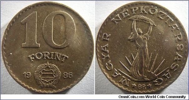 Hungary 1986 10 forint. A smaller coin than the ni-cupro version of 1980 10 forint that I have. Minted in bronze-like metal. Similar edging style with the older 10 forint.