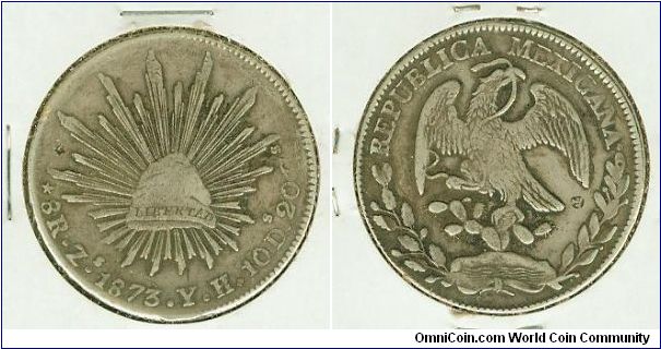 This is an 1873 Zs/YH  Silver Cap n' Rays 8 Reales from Mexico. These coins were legal tender in the Philippines,  during the Spanish occupation. This one has some very nice, light Chinese chopmarks on both sides, NOT to be confused with a counterstamp', which is something ALLtogether different.