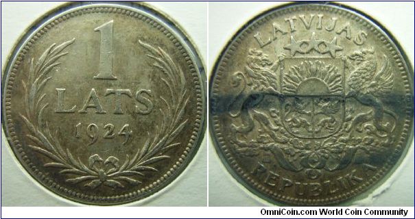 Latvia 1924 1 lats. Small but very nice. Somewhat XF. I can't explain how the black lines occur at the reverse.