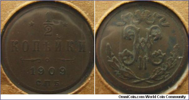 Russia 1909 1/2 kopek. Chocolate brown color with verdigis - not too appetizing is it?