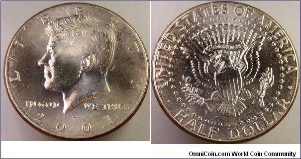 2001 Kennedy Half fresh from mint roll. Dings all over obverse but reverse has Die Flow fault. Does not show up well in these pics.