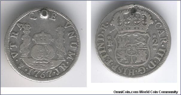 Spanish Milled 2 Reale, raw, holed. Hole was original, they holed these coins to wear around their neck so it would be harder to steal. Still reduces the value quite a bit though.