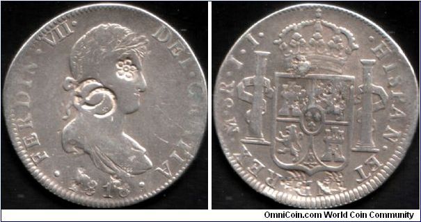 Eight reales which has been counterstamped (obverse)and two chops (reverse) at bottom rim. Minted at Mexico City