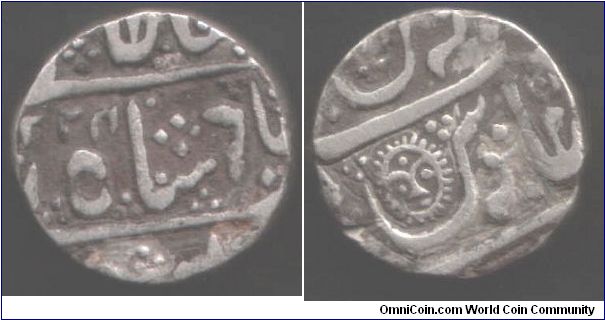 Silver rupee with a smiley face on it from Indore, an Indian State. Minted at Malharnagar AH1224 (1809)