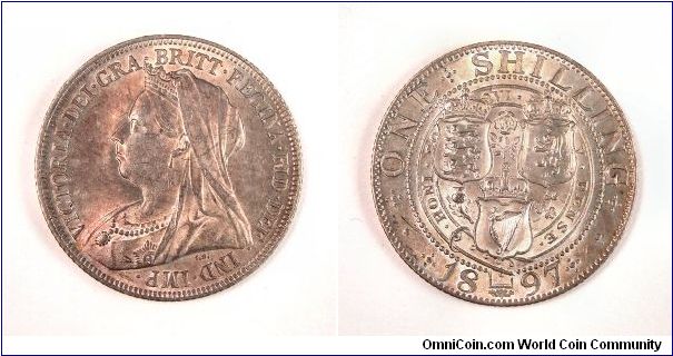 Beautiful rose toned silver one shilling.