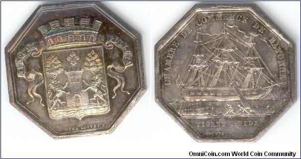 1860 - 79 silver jeton - Bayonne Chamber of Commerce. Obverse, arms of Bayonne. Reverse, harbour scene with ship being unloaded. `Bee' privy mark.