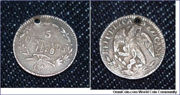 Mexican 5 centavo, holed. I've never seen this type before, and the 8 in the date is raised, a possible counterfiet?