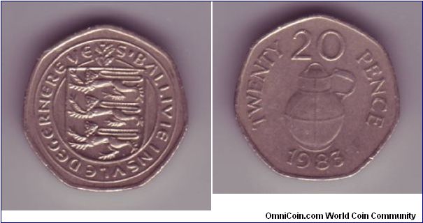 Guernsey - 20p - 1983

Reverse showing a milk jug.


The original decimal series introduced by Guernsey, rather oddly, didn't feature a portrait of Queen Elizabeth II. 

Instead the coins issued continued to bare the same designs on the obverse as used on the last series of pre decimal coins.

However all Guernsey coins from 1985 replaced the Guernsey sheild with a portrait of the Queen although the shield is still present, behind the Queen's head.