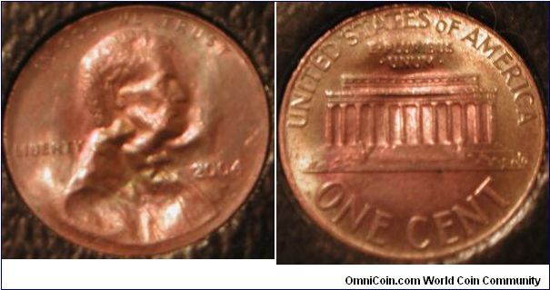 Error:

2004 cent which is either a brockage coin, or was struck through metal.

This is a recent bank roll find.

EDIT: Got some new information recently that suggests the possibility that this coin was actually intentionally altered after it left the mint. I'm keeping it here just in case, but after looking closer, I agree with the suspicions.