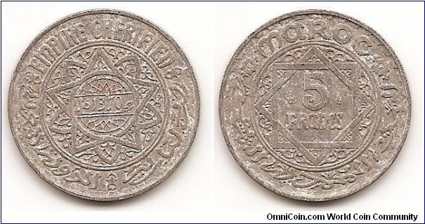 5 Francs
Y#48
Aluminum, 25 mm. Obv: Date within small circle of doubled trilobe
star, all within circle Rev: Value flanked by marks in doubled
square within circle