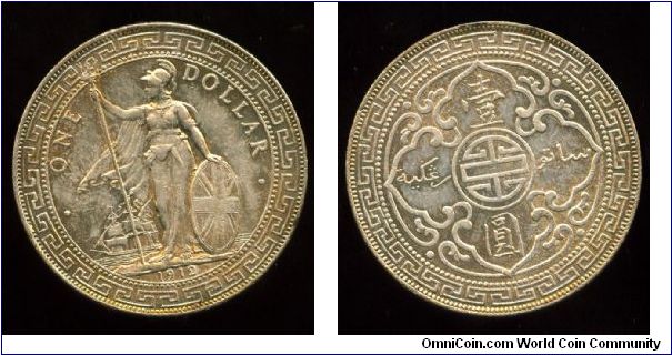 1912
$1 Trade Dollar
Britannia standing on the shoreline holding Shield & trident, ship in background
Arabesque design with the Chinese symbol for longevity in the center. Value in two languages, Chinese & Malay
Mint Mrk B = Bombay