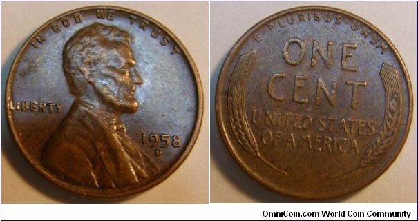 Big impression   on the face
Bronze/Dark Brown Tone
1958D Wheat Penny
Composition: .950 Copper, .05 Tin and Zinc 
Diameter: 19 mm 
Weight: 3.11 grams 
Edge: Plain