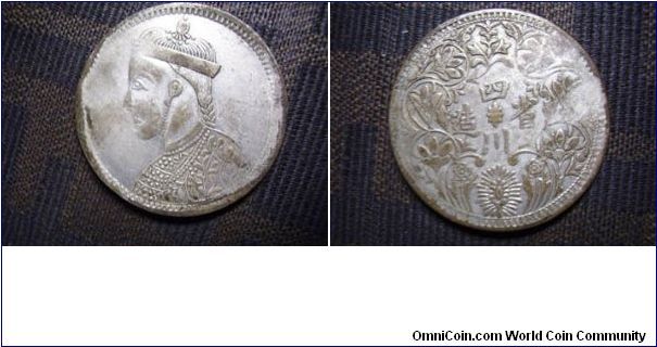 This is a China SI CHUAN Province RUPPE.And it has many types for different flowers,different head ,low sliver or high sliver.It is not a fake ,but they are always ROUGH~~And it is the first kind coin with a people's face on in China.The first kind of Ruppe made in 1902 ,when India Ruppe entered into Si chuan(nearly India with Tibet).The governor thought he should got an idea to boycott the India Ruppe,so he let the people in Si chuan made Si chuan Ruppe to do it.This one is one of mine,it is a