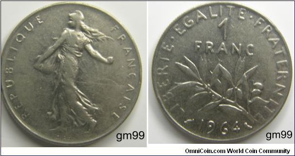 Liberty walking left, sun with rays on right in background,
REPUBLIQUE FRANCAISE
Reverse; Stalk below value,
LIBERTE EGALITE FRATERNITE 1 FRANC date 1964(Nickel)