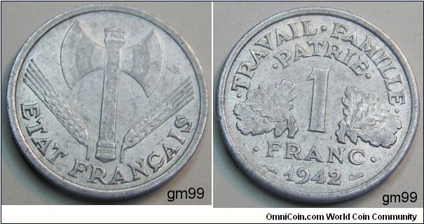 1 Franc (Aluminum) Obverse: Double-headed axe with wheat stalk either side, ETAT FRANCAIS
Reverse 1 between two leaves,
TRAVAIL FAMILIE PATRIE 1 FRANC date:1942
