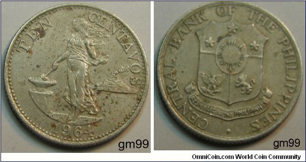 Obverse: Woman walking left, anvil to left, volcano in background to right,
TEN CENTAVOS 
Reverse: Shield,
CENTRAL BANK OF THE PHILIPPINES