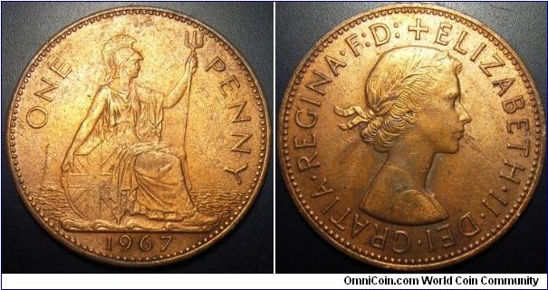 UK 1967 1 penny. Looks like the Queen is spitting. Cleaned.