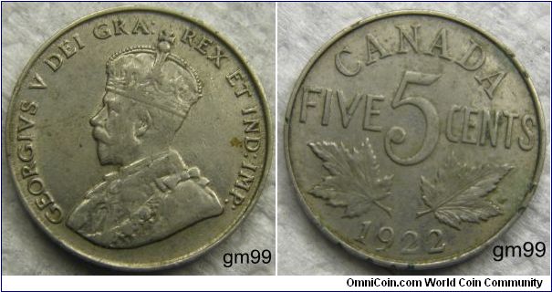 Obverse; King George V left. Reverse; Maple leaves divides denomination and date, composition: Nickel.
5 Cents
