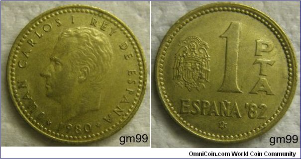 1 Peseta 
Obverse: Bare head of Juan Carlos left,
JUAN CARLOS I REY DE ESPANA 1980 Reverse: Crowned arms of Spain to left of 1, date on star below ESPANA 80,
1 PTA ESPANA 82