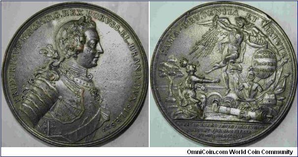 Frederick the Great. Obverse Legend: FRIDERICVS MAGN. D.G.REX BORVSS. EL. BRAND. DVX SILES. 
Reverse: FAMA PRVDENTIA VIRTVTE. Engraver Holtzhey In exergue: AVSTIR-EXERC- PROPE-PRAGEVNDIT-CAESOET-PRAGA OBSESSA VI MAJI MDCCLVII. Half-length bust right, rev Victory kicks Bohemia, knocking off her crown, 48mm (Olding 604a).