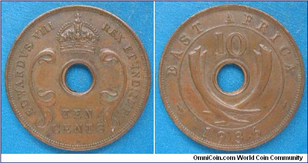 British East Africa (the Kenya Colony), 10 cents, Cu, holed.  Reverse features elephant tusks.