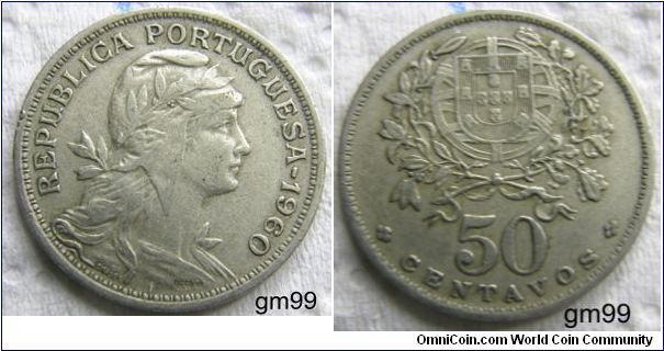 Copper-Nickel 50 Centavos.Obverse:  Head of the personification of the Republic right, wearing wreath 
REPUBLICA PORTUGUESA date 
Reverse:  Shield having seven castle towers surrounding five shields in the form of a cross, each with five dots on it, all superimposed upon globe, within wreath, value below 
50 CENTAVOS