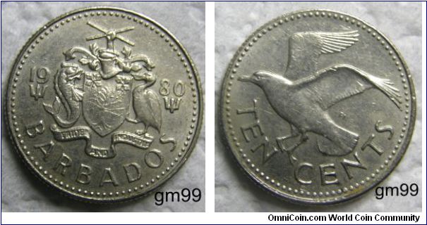 10 Cents (Copper-Nickel) : 1973-2001
Obverse: Date separated by arms, trident below each half of date, shield with Bearded Fig tree on it, Pride of Barbados flower in each upper corner, dolphin to left and pelican to right, above is a helmet and a hand holding two crossed pieces of sugarcane,
 date BARBADOS PRIDE AND INDUSTRY (on banner)
Reverse: Bonaparte Tern flying left,
 TEN CENTS