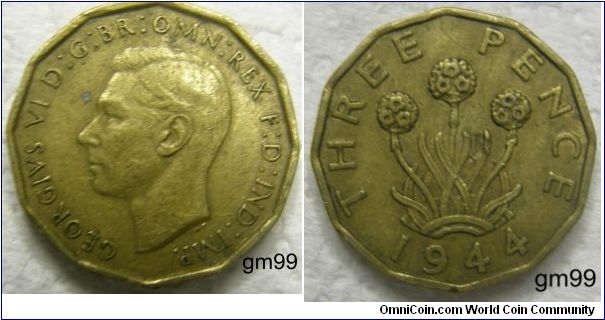 Threepence (1937-1948)
Obverse;  Bare head of George VI left 
GEORGIVS VI D:G:BR:OMN:REX F:D:IND:IMP. 
Reverse;  Thrift plant, dodecagonal 
THREE PENCE date