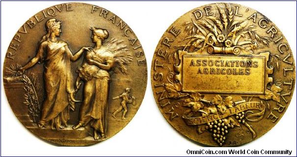 France, Minister of Agriculture, Agricultural associations prize medal, 1900, designer: Alphee Dubois, 50mm. Obverse: Marianne & Ceres standing, Marianne points to Science book, a man sows seed in the background, REPVBLIQVE FRANCAISE around. Rev: Corn , vine and grapes around central tablet with ASSOCIATIONS AGRICOLES, and MINISTERE DE L'AGRICULTURE around.
