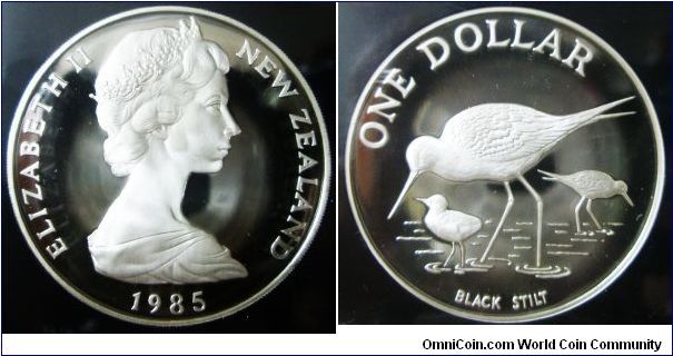 New Zealand, Queen Elizabeth II, One Dollar, 1985. 27.216 gms, 0.925 Silver, diam. 38.735, grained edge. Obverse: Elizabeth II New Zealand 1985 around the perihery. Reverse: The black stilt, endemic to New Zealand, is currently the world's rarest wading bird. PROOF.