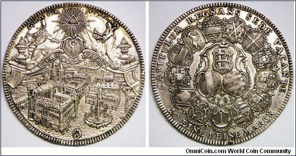 German States - Eichstatt (Bishopric), Sede Vacante, Thaler, 1781 KR/OE. Subject: Sede Vacante Issue. Obverse: Gottesauge (Eye of God) above view of city within baroque frame with arms of bishopric in center flanked by Saints Willibald and Walburga seated on clouds, urns to left and right labeled S. WIL and S. WAL. Reverse: 13 oval arms form circle with 3 shields of arms and date within ornate frame at center. Note: Convention Thaler. 27.9500 g, Silver, 41.2mm. Extra fine.