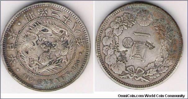 Meiji Emperor, year 28.  1 Yen, silver; countermark Gin, left.  This coin was demonetized at the Osaka mint, and sent to Taiwan as silver trade bullion. Several trade chopmarks featured obverse and reverse.