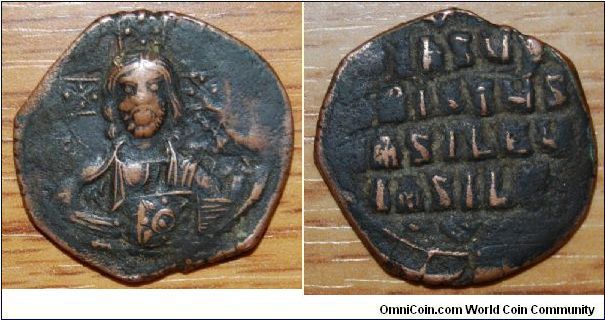 Byzantine Coin.
Anonymous Byzantine follis, class A3
Constantinople, c1020-1030 AD
obv legend: +EMMANOVHA IX-XC
obv design: facing bust of nimbate Christ, holding the Gospels in both hands
rev legend: +IhSUS XRISTUS bASILEU IASILE, in four lines.
ref: Sear 1818
