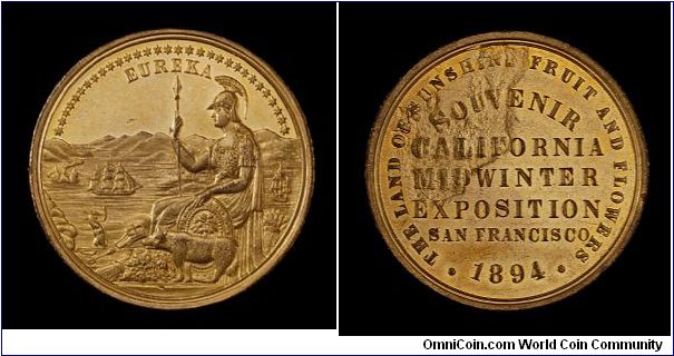 Gold-plated California Midwinter International Exposition medal. Reverse struck through a scrap of cloth or grease.