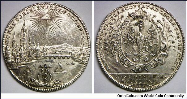 German States - Frankfurt am Main, Thaler (Konventionstaler), 1772. 27.94g, Silver, 40mm. Obv.: NOMEN DOMINI TVRRIS FORTISSIMA, Gottesauge (Eye of God) above view of city with river in middle, in foreground two cornucopias flanking winged caduceus, minute letters OE below. Rev.: MONETA REIPVBL. FRANCOFVRT. AD LEGEM CONVENTIONIS, coat of arms, in exergue X. STEINE F. M./MDCCLXXII and P.C.B. in frame. Adjustment marks on reserve center.  A beautiful city view thaler. AU+.