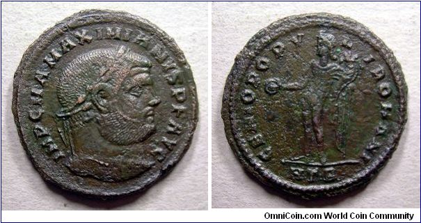 Maximianus AE Follis. AD 297-298. IMP C M A MAXIMIANVS P F AVG, laureate head right / GENIO POPVLI ROMANI, Genius standing left, holding patera & cornucopia, HTB in ex. - Mm 28 gr. 9,6