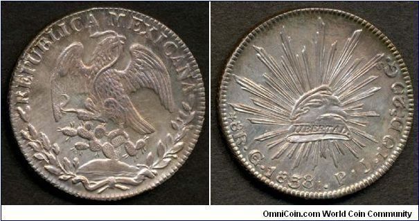 Republic, 8 Reales, 1838Go PJ, 27.07g, 0.9030 Silver, .7859 oz. ASW, 38mm. Mint: Guanajuato. This is the earlier type Mexico eagle coinage, which is scarcer than post-1860s type, particular in this sharply struck superb gem condition. Eye appealing natural purplish gold toning with a dash of irridescent blue highlight. Both sides show clear evidence of clashed dies.  The eagle has the rays from the other side surrounding much of its profile.  Interesting and attractive effect.