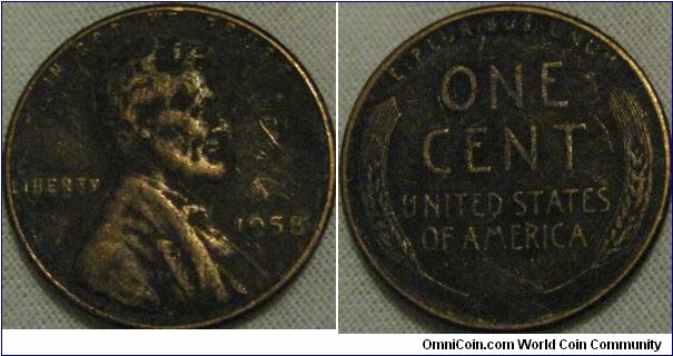 dirty 1958 1 cent, looks good in black, not going to try and clean as the dirt seems to fairly old and adds to the coin