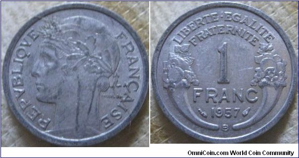 VF, 1957 B 1 franc, shows some scuffing from circulation, common with the weakness of aluminium, some lustre on reverse, better mint though