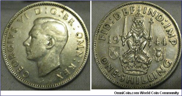 VF 1944 500. silver shilling, higher grade then the norimal, birght coin, but wear on the thistle and detail on hair means it is VF.
