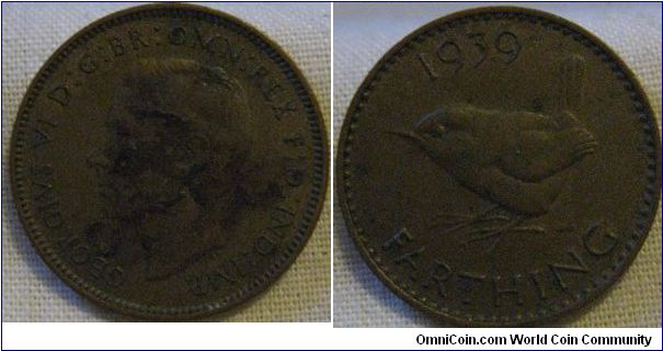 EF 1939 farthing, war damaged with a melt on the obverse which could be damage from a bomb in the war, a wonderful piece if it is