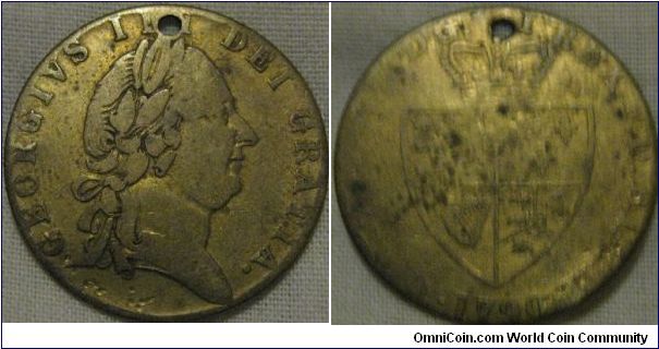 a forgery? of a guinea coin, as it looks well circulated so i would point it towards that rather then a gaming chip