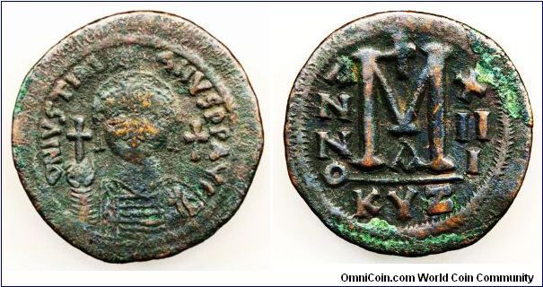 Byzantine IUSTINIANUS I, bronze Follis 527-565 AD, Obv. Helmeted and cuirassed bust facing holding globus cruciger and shield, cross to right, 'dn ivstinianvs pp avg'. Rev. large 'M' between anno and xii i, in ex. KYZ . 20.7g, 44mm. Crude good fine or better. Very nice specimen.
