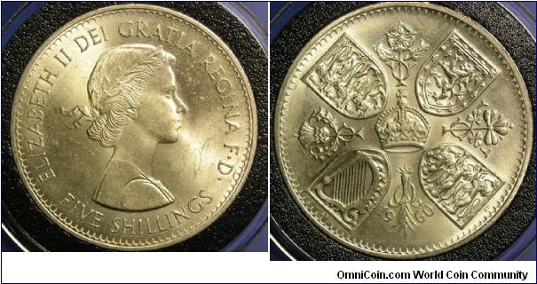 1960 Crown (5 Shillings)

Copper-Nickel, 38.61 mm
Ruler: Elizabeth II 
Subject: British Exhibition in New York
Obv: Laureate bust right
Rev: Crown at center of cross formed by rose, shamrock, leek and thistle; shields in angles
Mintage: 1,024,000

KM # 909