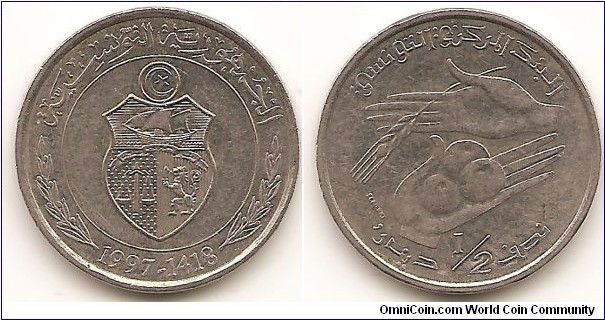 1/2 Dinar -AH1418-
KM#346
Copper-Nickel Obv: Shield within circle Rev: 2 Hands with fruit and wheat sprig