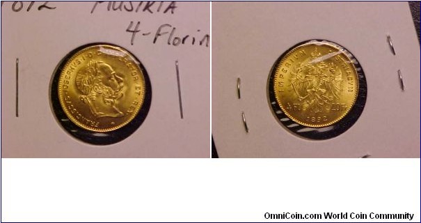 A nice 1892 4-Florin or 10-Frank gold coin with Emporer Franz Joseph on the obverse.  This is a small coin, most likely a restrike made for bullion purposes but still a very pretty coin with about 1/10th of an ounce of gold.