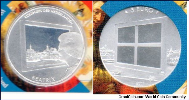 5 euros 
Art of Painting
Queen Beatrix looks at part of Jan Vermeer's View of Delft while the other side of the coin shows the empty frame or the back surrounded by the rest of the painting
Silver plated in coinholder