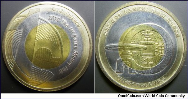 Korea 2010 medal commemorating 1st coin fair. Struck on tri-metal planchet. Pretty neat. 

Core : Cu 65% Zn 35%
Inner Ring : Cu 75% Ni 25% 
Outer Ring : Cu 75% Ni 4% Zn 21%

Weight: 10.12g.  